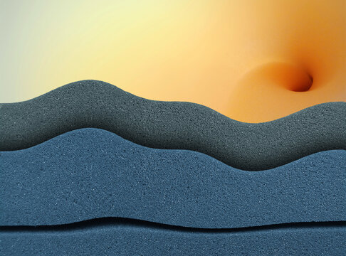 pile of wavy blue and gray sponge foam against a spiral shaped yellow sponge foam roll background. creativity with a beautiful and unique style