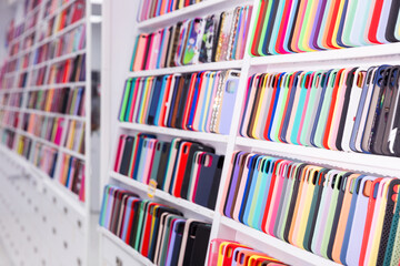 New smartphones on display shelves in an electronics store
