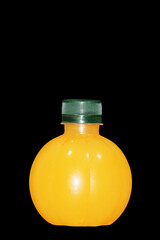 Round orange juice bottle on black background