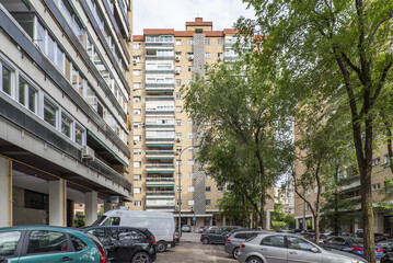 Facades of high-rise urban residential buildings with large parking areas