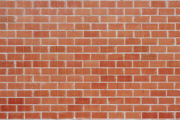 Wall of clay bricks with scratches