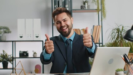 Like. Happy young Caucasian businessman guy working on laptop looking approvingly at camera showing thumbs up, like sign positive something good, positive feedback at office workplace. Freelancer man
