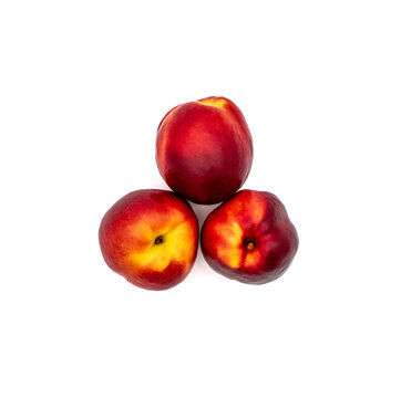 Close up studio photo of three ripe whole nectarine fruits