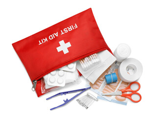 Red first aid kit with scissors, pins, cotton buds, pills, plastic forceps, medical plasters and elastic bandage isolated on white, top view