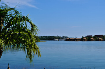 Beautiful Lake reflecting buildings in distance in a tropical setting