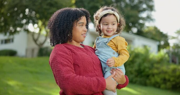 Family, kids and a mother with her adopted daughter in the garden of their foster home together. Love, smile and children with a stepmother holding her female child outdoor in the home backyard