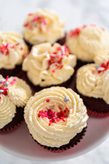 Obraz na płótnie Canvas Red Velvet Cupcakes with White Chocolate Ganache Frosting
