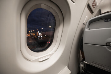 Commercial aircraft cabin window looking at tarmac