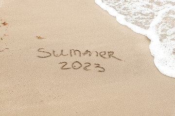 Summer 2023 written on the sand