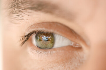 Close-up of a male eye that reflects beach