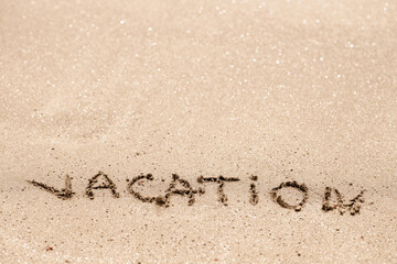 Fototapeta premium Word vacation written on the sand