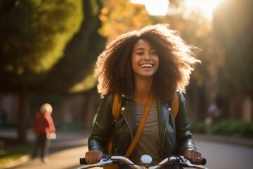 Hipster smiling black woman confident as she is commuting riding her bicycle