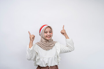 Happy young Asian muslim woman celebrate Indonesian independence day showing thumb up gesture isolated on white background. Indonesian independence day concept