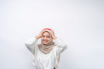 Shocked Asian muslim woman celebrate Indonesian independence day isolated on white background. Indonesian independence day on 17 august concept
