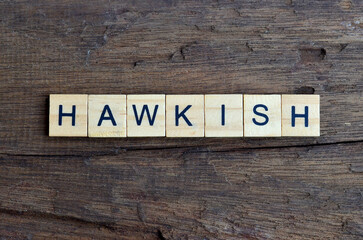 hawkish text on wooden square, business quotes
