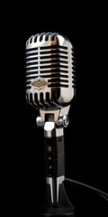 Fototapeta premium Retro microphone on a black background. Vintage microphon - Generative AI
