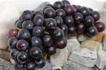 Black grapes on texture background
