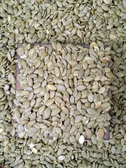 Fresh pumpkin seeds in the traditional wooden measuring bowl at the Korean open market