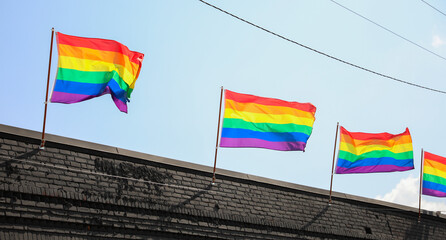 Vibrant gay pride rainbow flag intertwines with Juneteenth symbolism, celebrating freedom, equality, and diversity in a powerful fusion