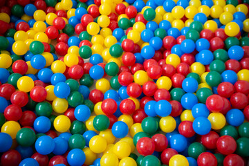 Fototapeta na wymiar Colorful ball pool. Several balls of different colors concentrated in a pool.
