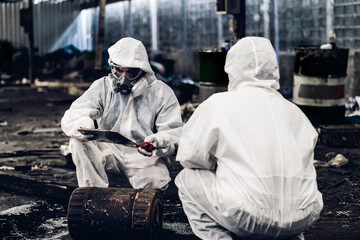 Scientist wear Chemical protection suit check danger chemical, working at dangerous zone in Red and White Lines of barrier tape. Red and white Hazardous restricted area factory safety worker industry