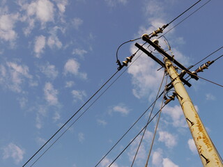 Power lines against blue sky.