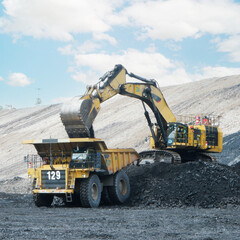 coal loading from excavator into truck, coal mine industry