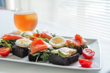 Open Sandwiches with Smoked Salmon, Avocado Cheese, Boiled egg on Squid Ink Bread