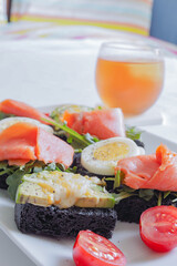 Open Sandwiches with Smoked Salmon, Avocado Cheese, Boiled egg on Squid Ink Bread