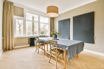 a dining room with a table, chairs and a blackboard on the wall in the room is very clean