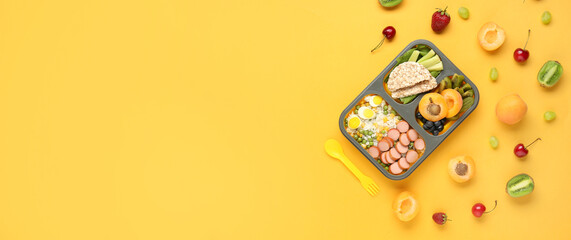 School lunch box with tasty food on yellow background with space for text