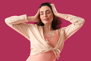 Attractive young woman in shirt on pink background