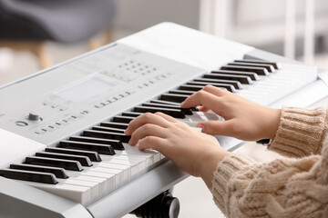 Obraz na płótnie Canvas Woman playing modern synthesizer, closeup