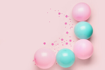 Blue and pink balloons with serpentine on color background