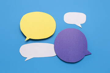 Blank paper speech bubbles on blue background