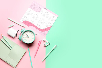 Composition with calendar, alarm clock, earphones and pencils on colorful background