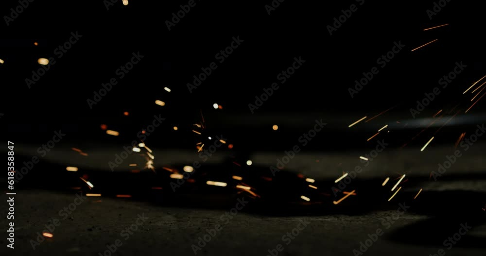 Poster Sparks sizzled and danced in a spectacular display as the tool struck against the metal, creating a mesmerizing shower of fiery particles.