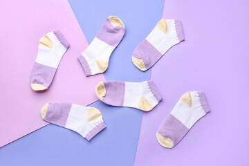 Many cotton socks on color background