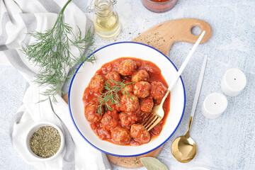 Bowl of tasty meat balls with tomato sauce and dill on white background