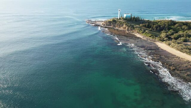 Iconic Point Cartwright Lighthouse Next To Water Tank With Breathtaking Coastal Views In Queensland, Australia. aerial pullback