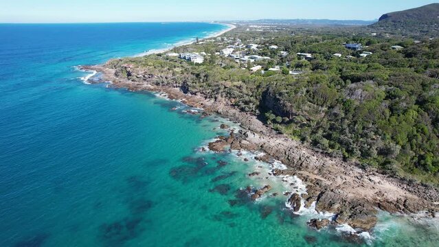 Shoreline Of The Bays Of Coolum With Turquoise Waters And Coastal Cliffs In Queensland, Australia. aerial