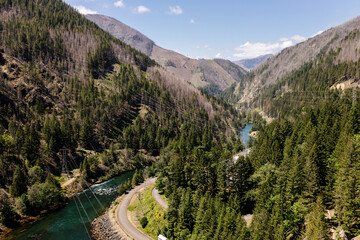 Beautiful view of the mountains and a large river from a bird's eye view. Beautiful summer landscape with mountains, trees and a river. Nature in Oregon in spring. Detroit Dam
