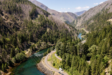 Beautiful view of the mountains and a large river from a bird's eye view. Beautiful summer landscape with mountains, trees and a river. Nature in Oregon in spring. Detroit Dam