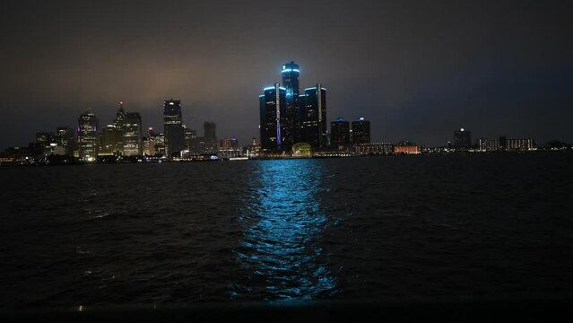 Skyline of Downtown Detroit, Michigan at night on a rainy day taken from across the Detroit river in Windsor, Ontario