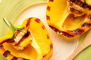 Halves of tasty grilled bell pepper on plate