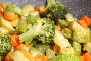 Different tasty vegetables on frying pan, closeup