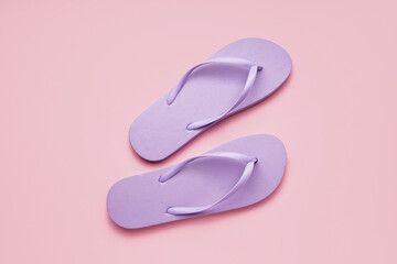 Lilac flip-flops on pink background