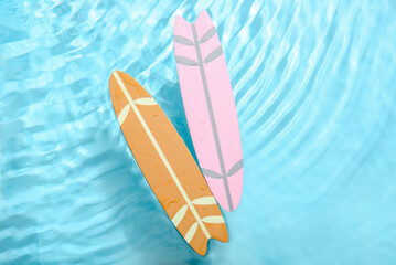 Different mini surfboards in water