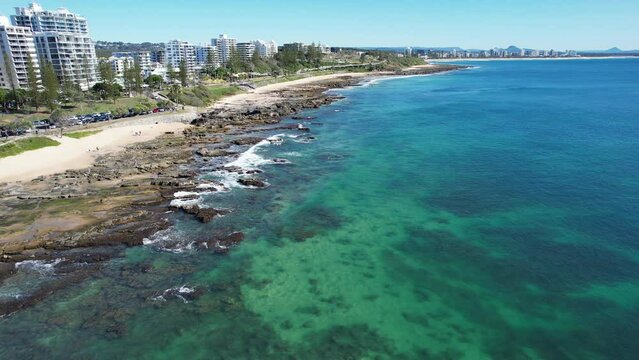 Rocky Shores And Holiday Apartments At Mooloolaba Beach In Sunshine Coast, Queensland. aerial pullback