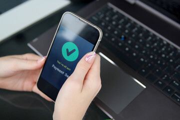 Woman using online banking on mobile phone. Payment sent.